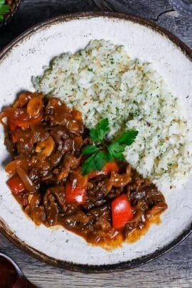 Beef Hayashi Rice on an off-white plate with brown rim