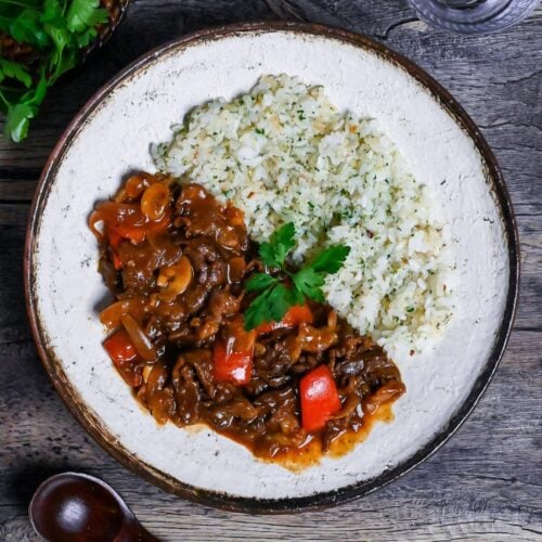 Beef Hayashi Rice on an off-white plate with brown rim