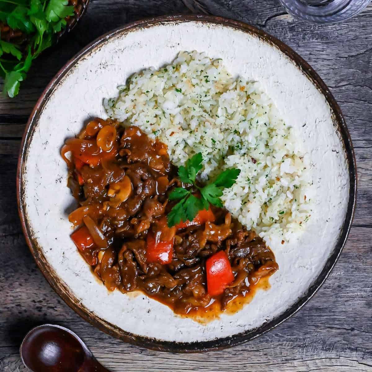 Beef Hayashi Rice on an off-white plate with brown rim
