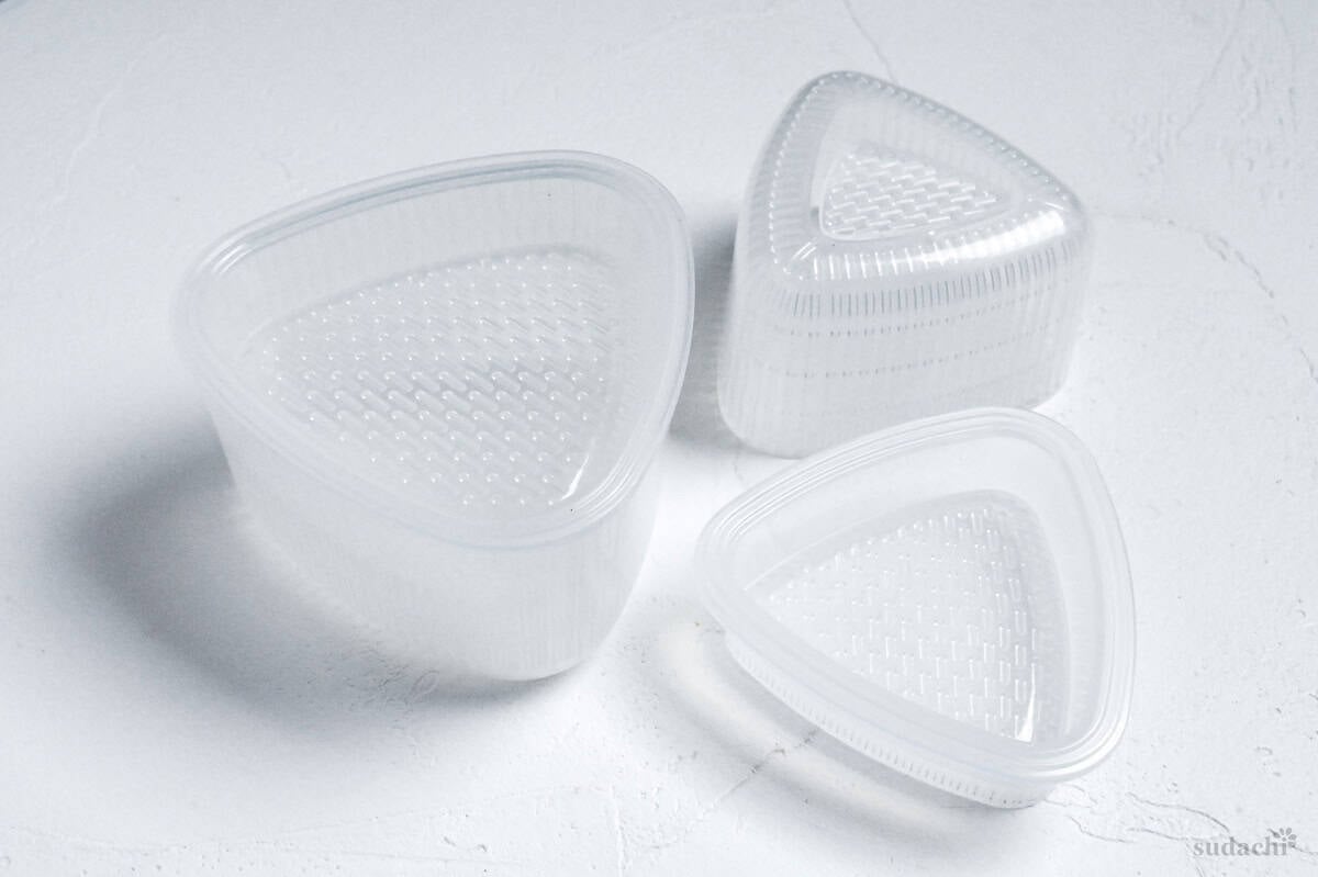 Plastic onigiri molds on a white background