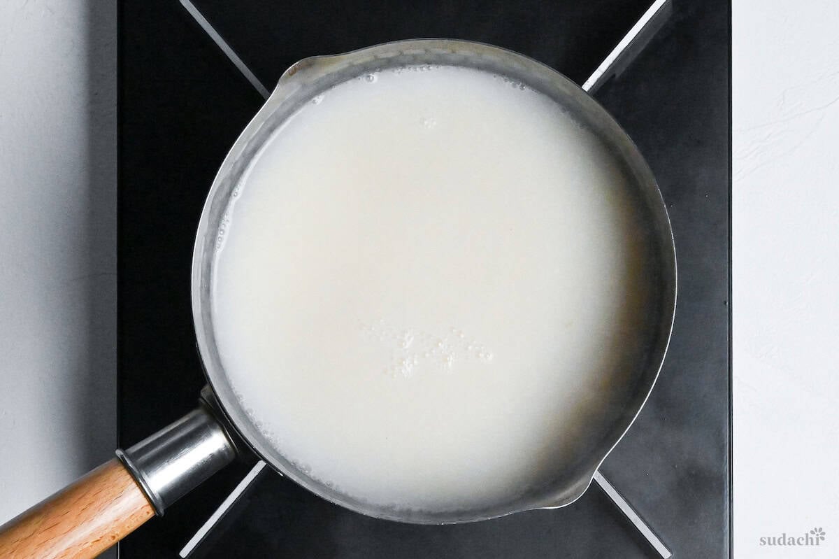 soy milk in tantanmen broth in a pot on the stove top