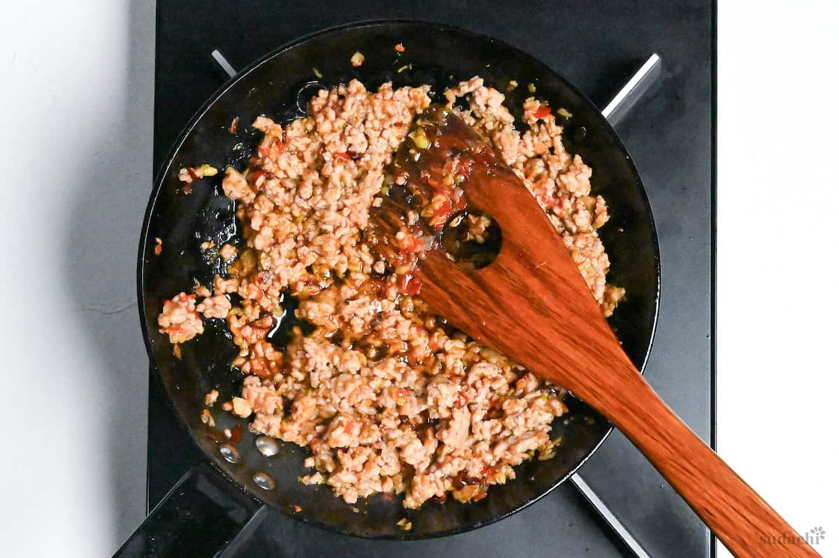 spicy ground pork for tantanmen in a frying pan on the stove