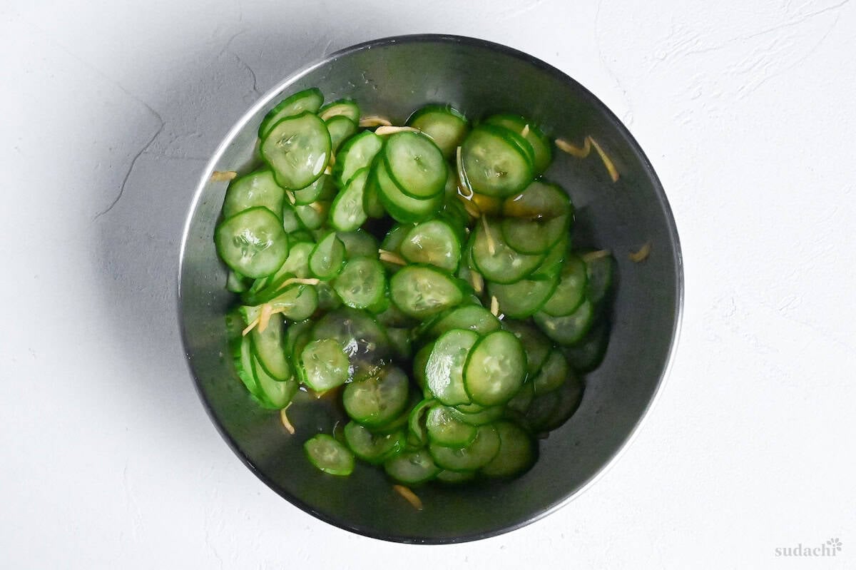 Final sunomono with Japanese cucumber and ginger root in a mixing bowl