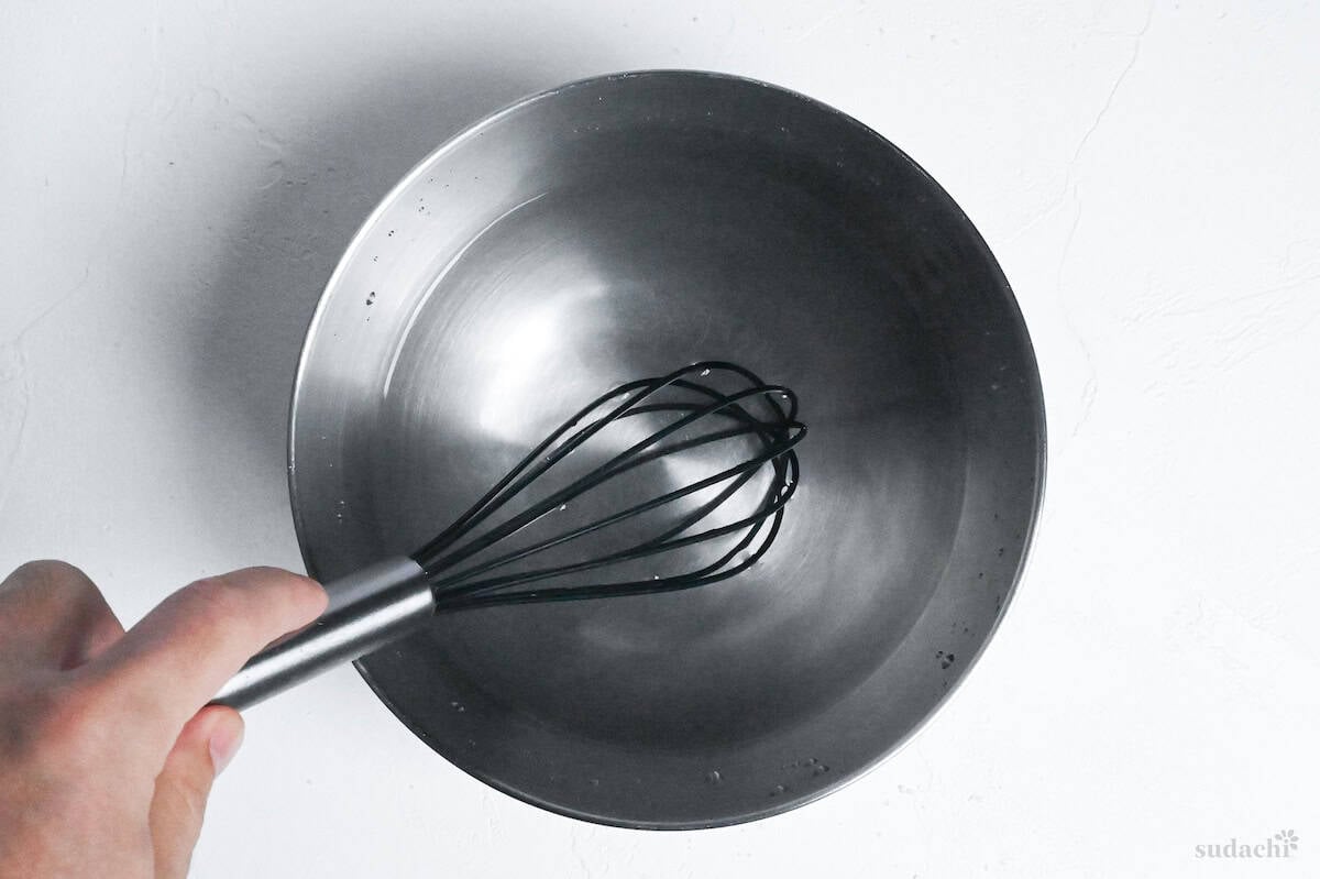 whisking salt and water together in a mixing bowl