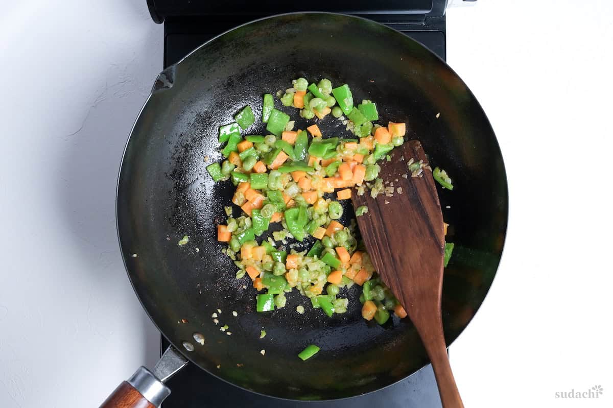 Softed vegetables in a wok for Japanese style curry fried rice