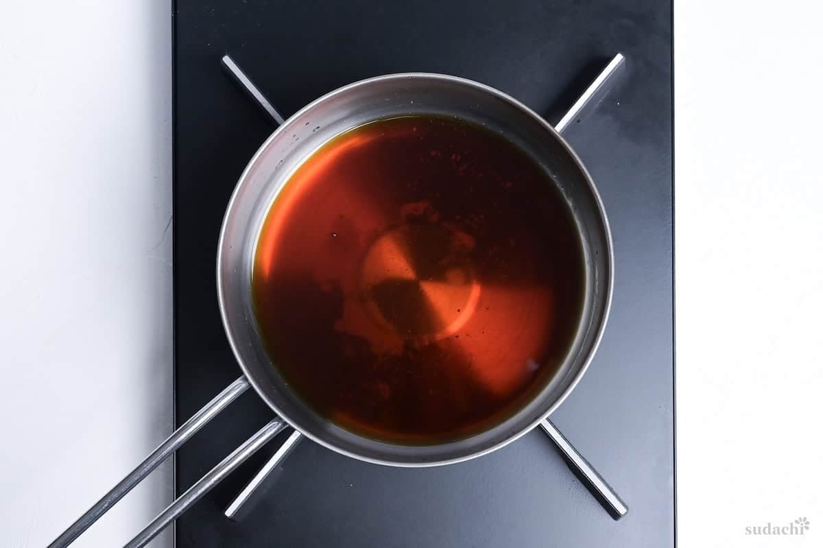 Making kake soba soup in a pot on the stove top