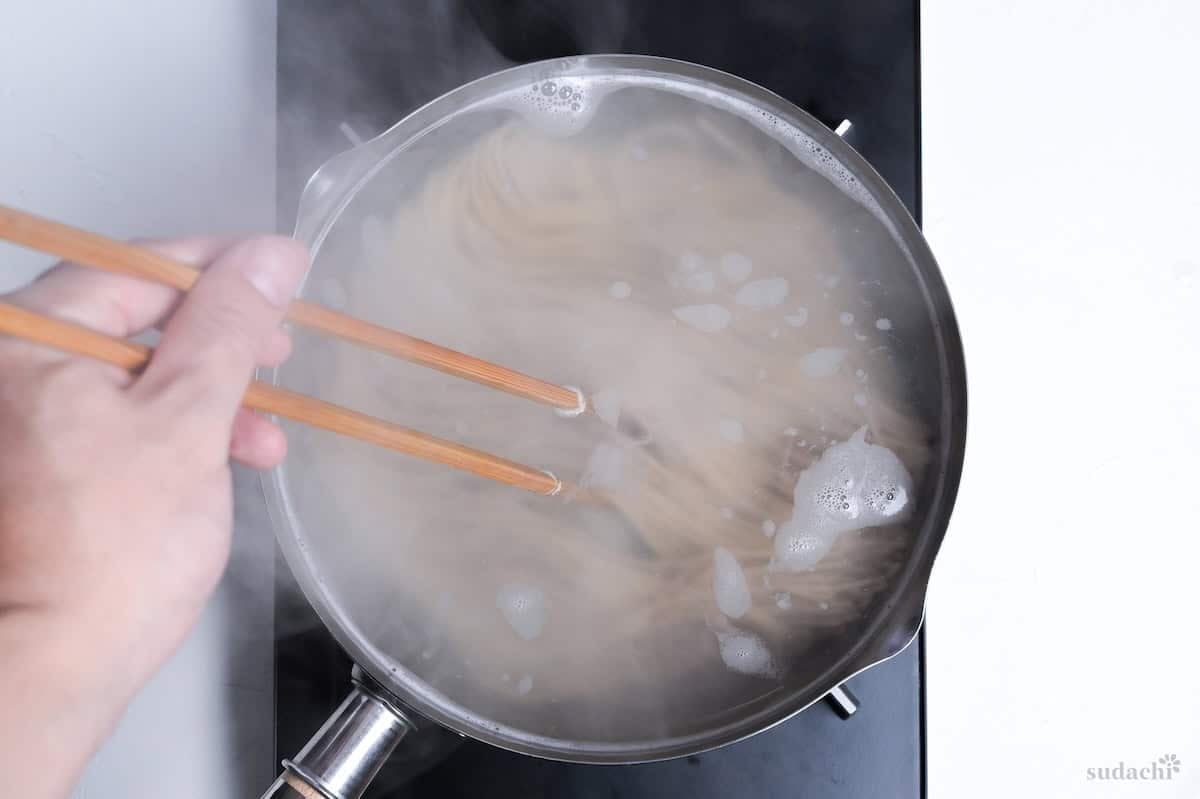 cooking soba noodles in a large Japanese yukihira pot on the stove