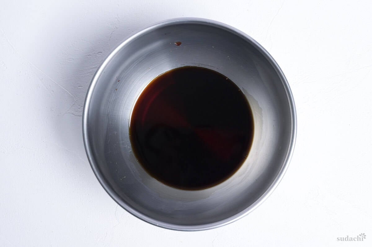 Soba noodle soup base in a steel mixing bowl