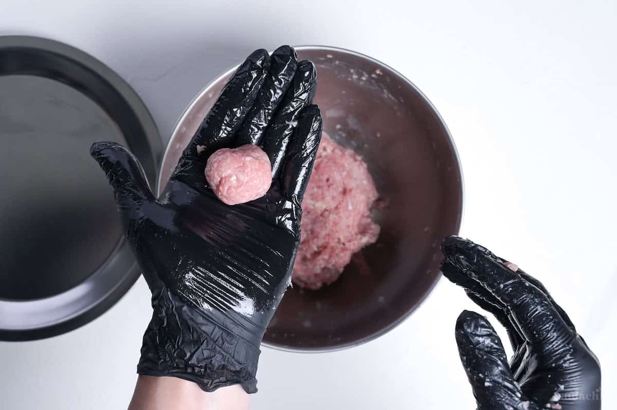 one pork meatball rolled into a ball