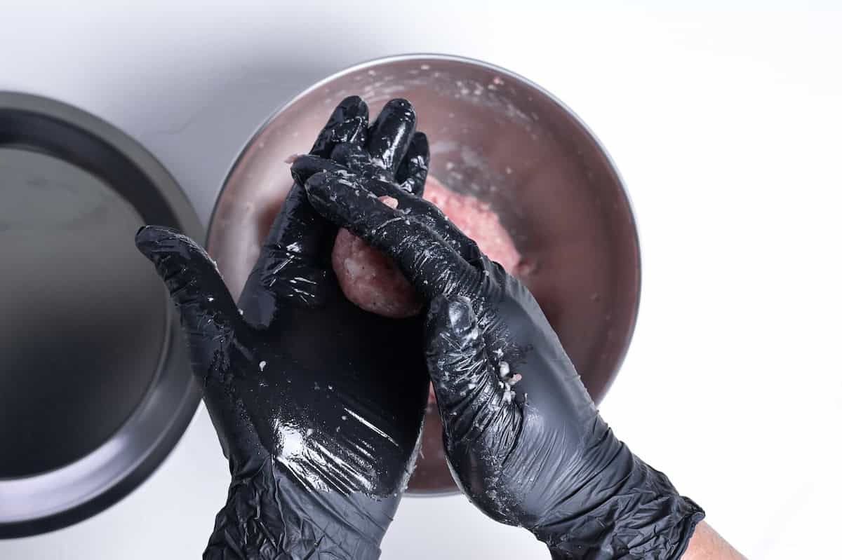 rolling ground pork mixture to make teriyaki meatballs