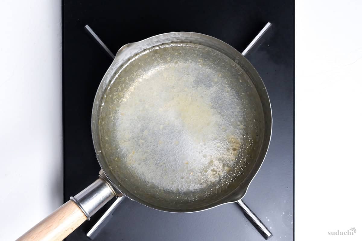 simmering wakame soup broth base in a pan on the stove top