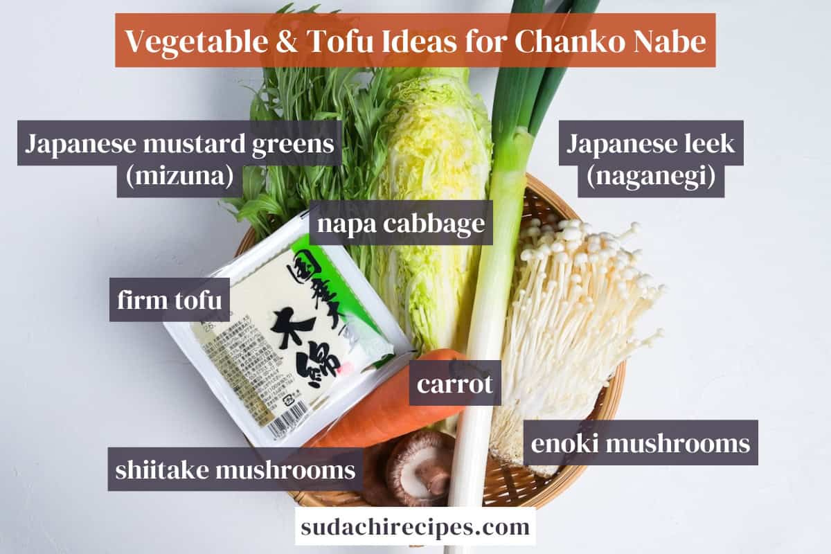 Vegetable and Tofu Ideas for Chanko Nabe in a bamboo basket. From top to bottom, left to right: Japanese mustard greens, napa cabbage, Japanese leek, firm tofu, carrot, shiitake mushrooms and enoki mushrooms