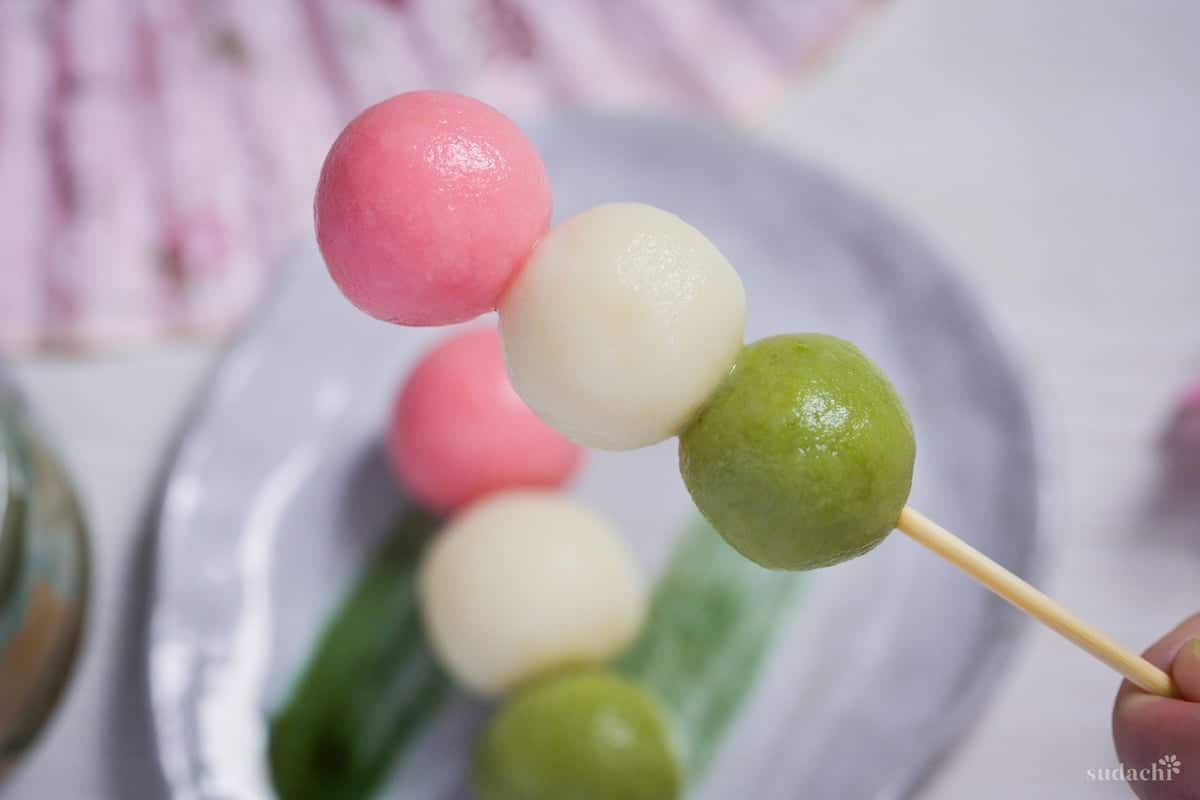 Tofu hanami dango (pink, white and green dango on a bamboo skewer)