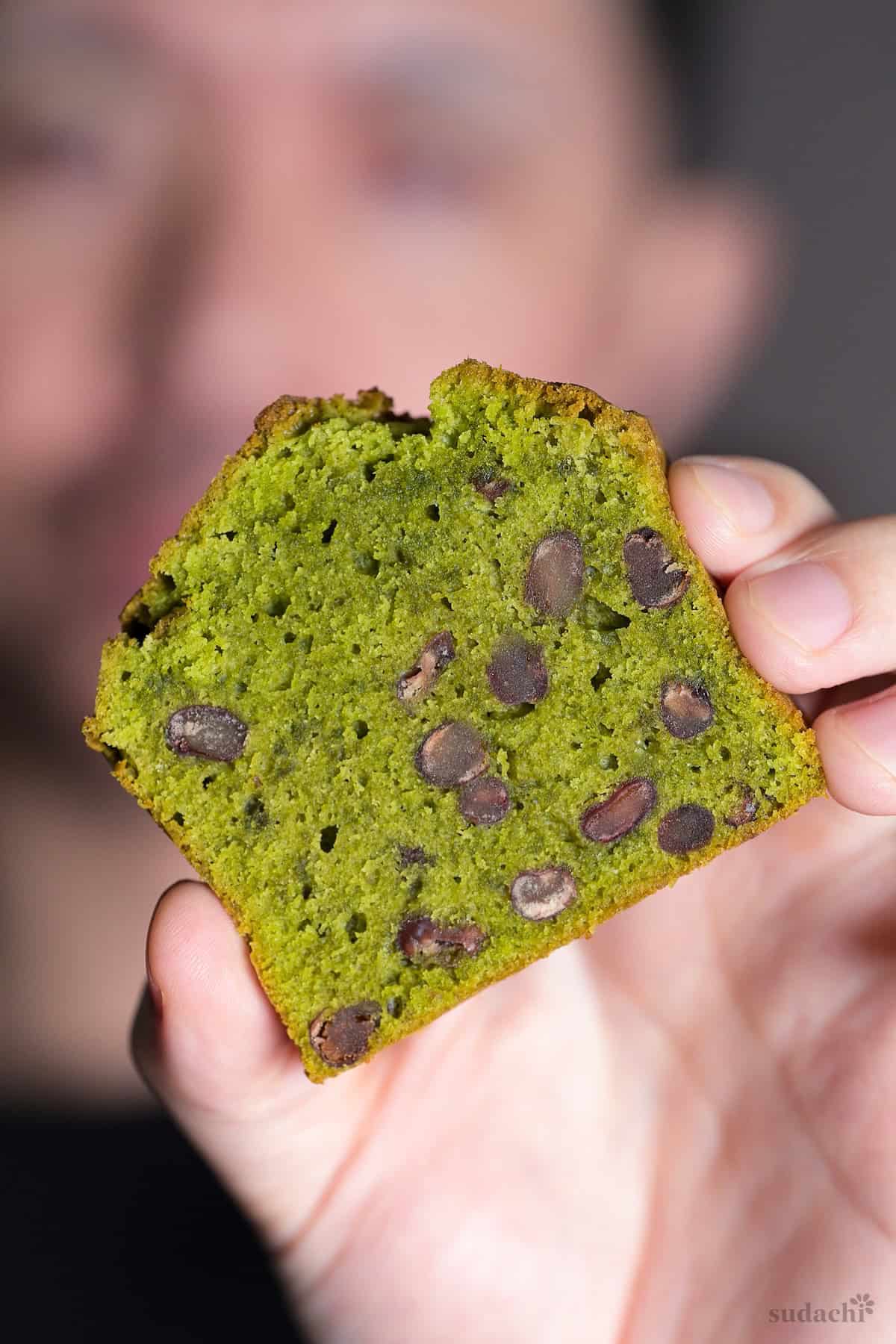 Yuto Omura holding up a slice of matcha and adzuki bean pound cake