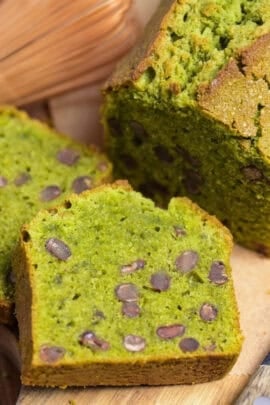Matcha and adzuki bean pound cake on a wooden cutting board with two slices stacked in front of it