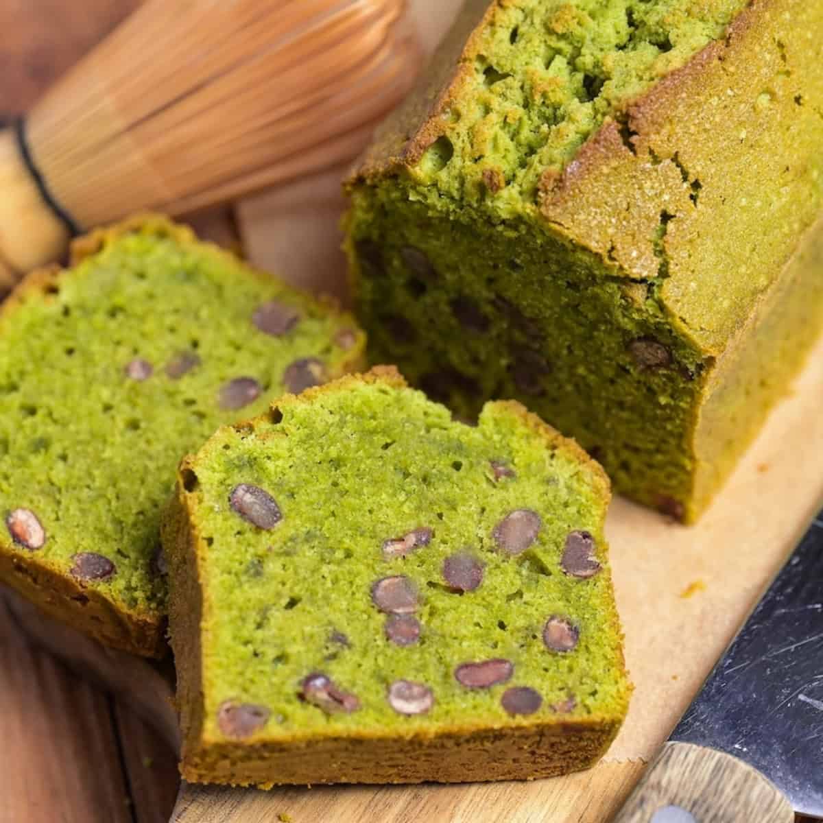 Matcha and adzuki bean pound cake on a wooden cutting board with two slices stacked in front of it