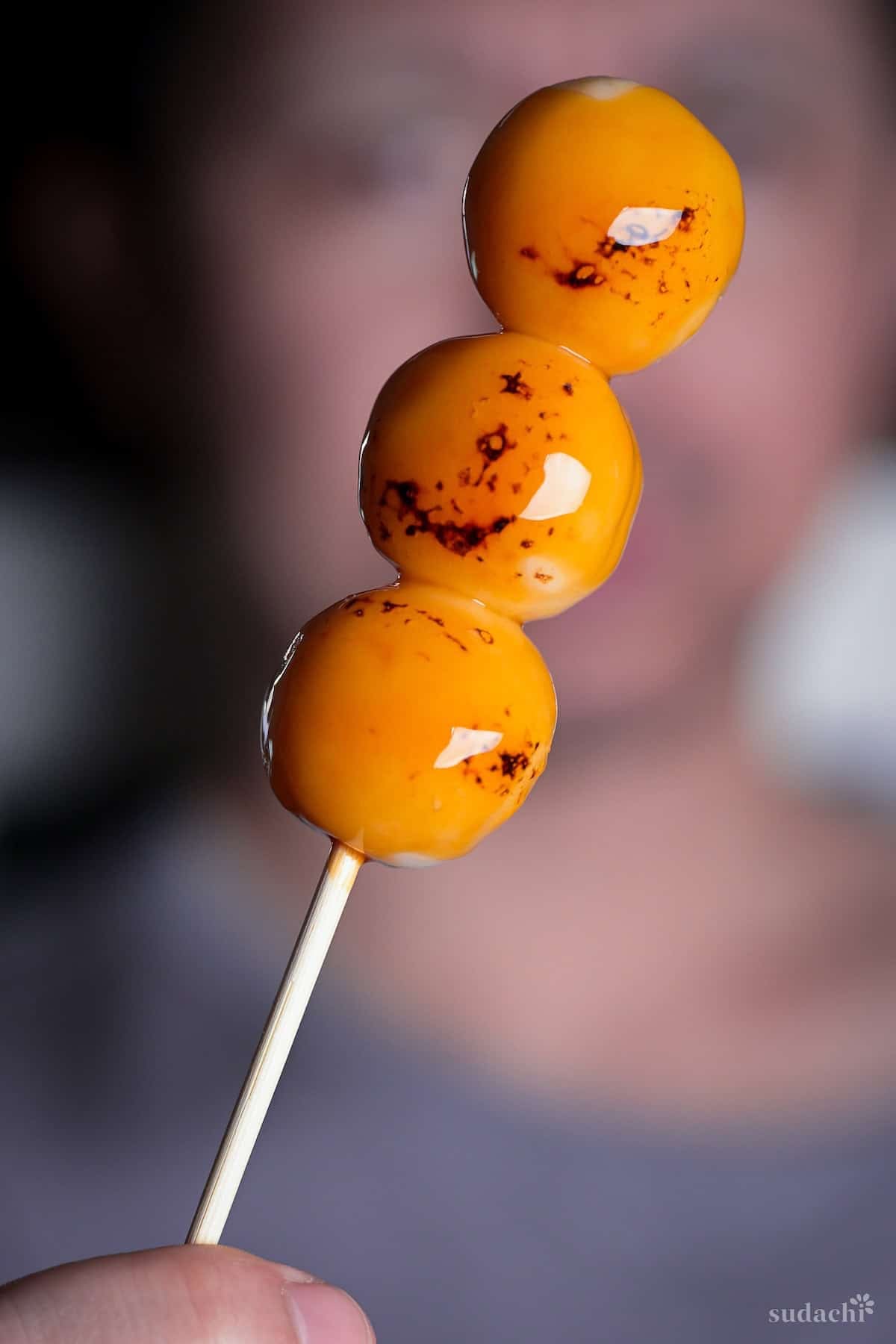 Yuto Omura holding up a homemade tofu mitarashi dango