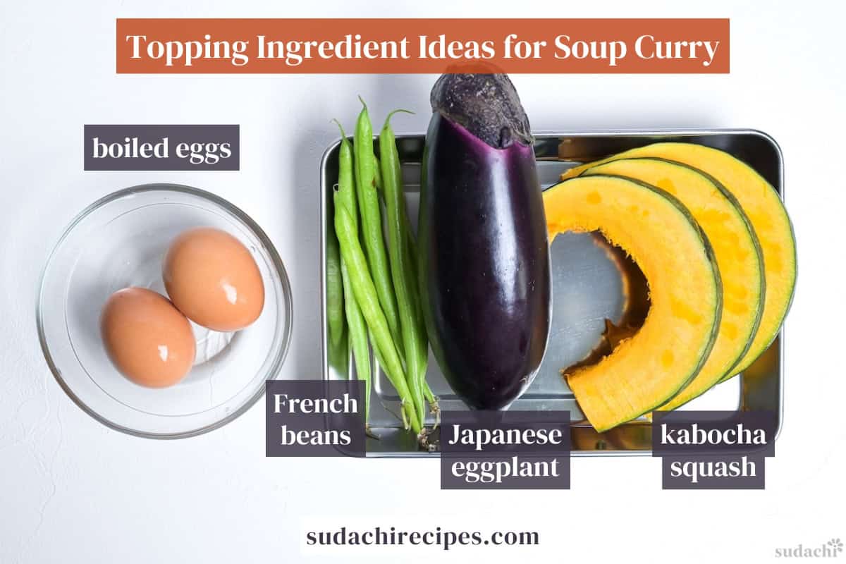 Topping Ingredient ideas for Japanese soup curry on a white surface with labels. Boiled eggs, French beans, Japanese eggplant, kabocha squash.