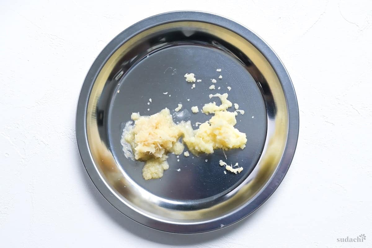 grated garlic and ginger on a steel prep plate