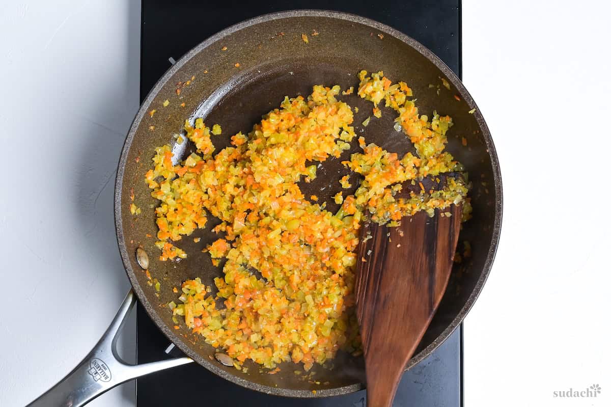 Soffrito frying in a pan on the stove top