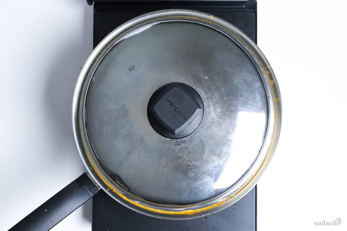 Japanese soup curry simmering in a pan with a lid on the stove top