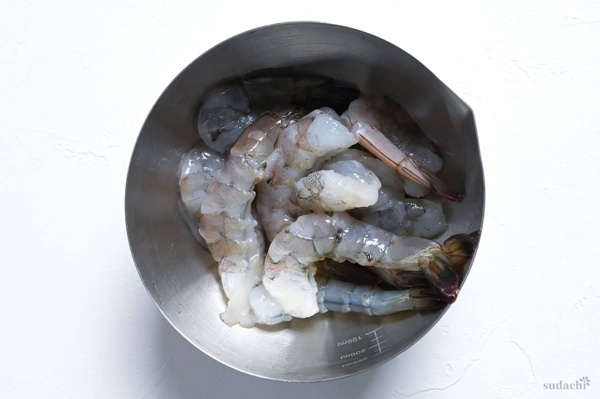 Deshelled and deveined prawns in a steel mixing bowl