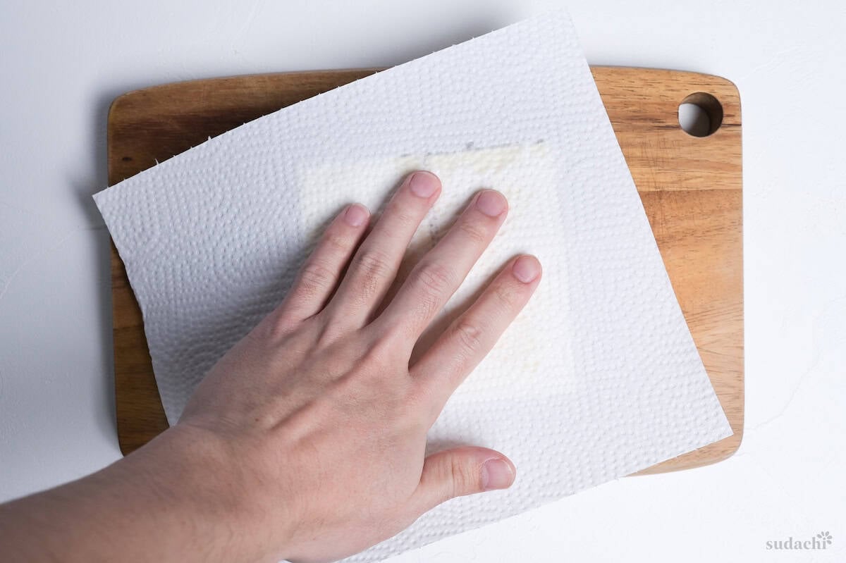 patting tofu dry with kitchen paper