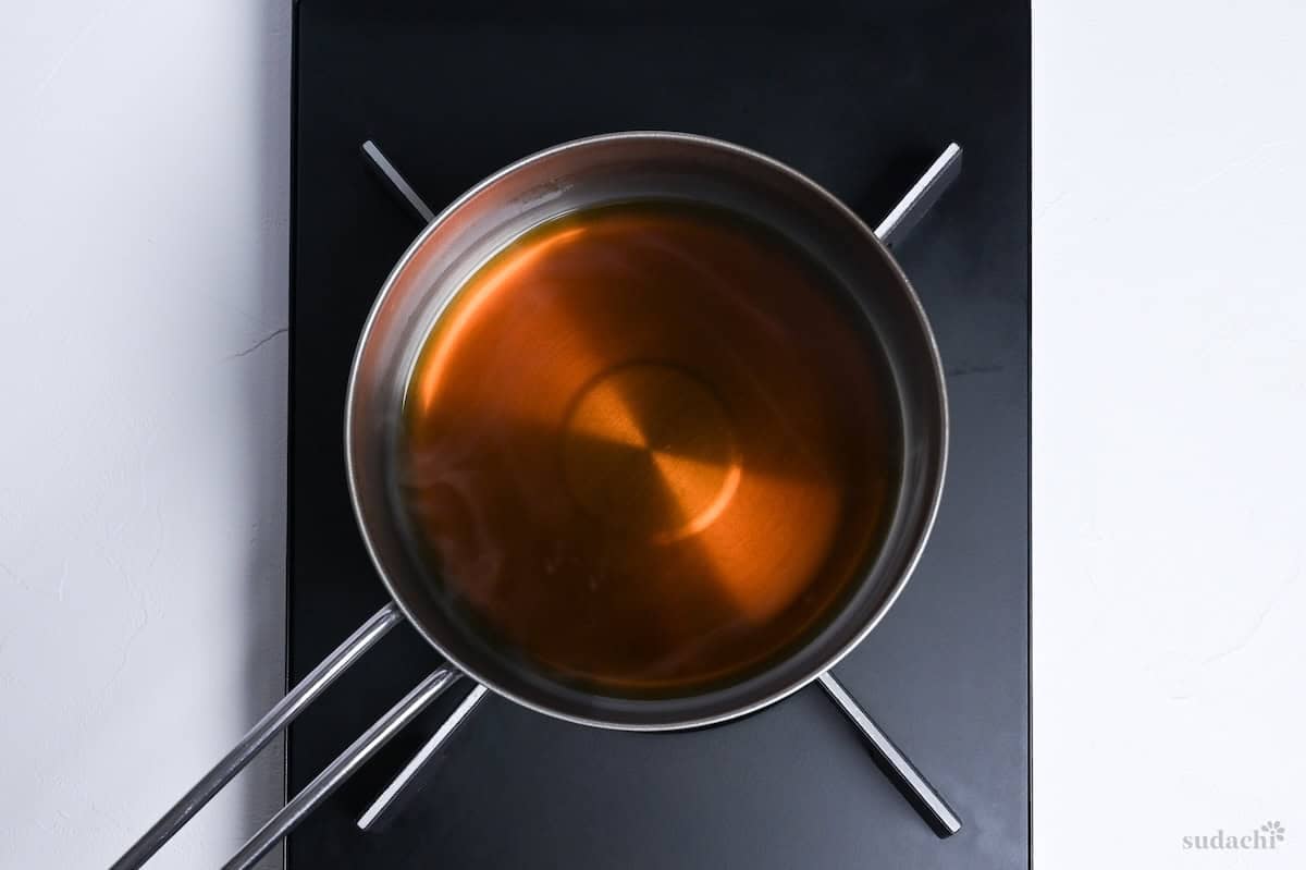 Dashi stock with mirin and soy sauce in a pot on the stove top
