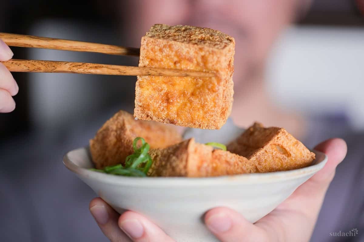 Yuto Omura holding up a piece of homemade atsuage tofu
