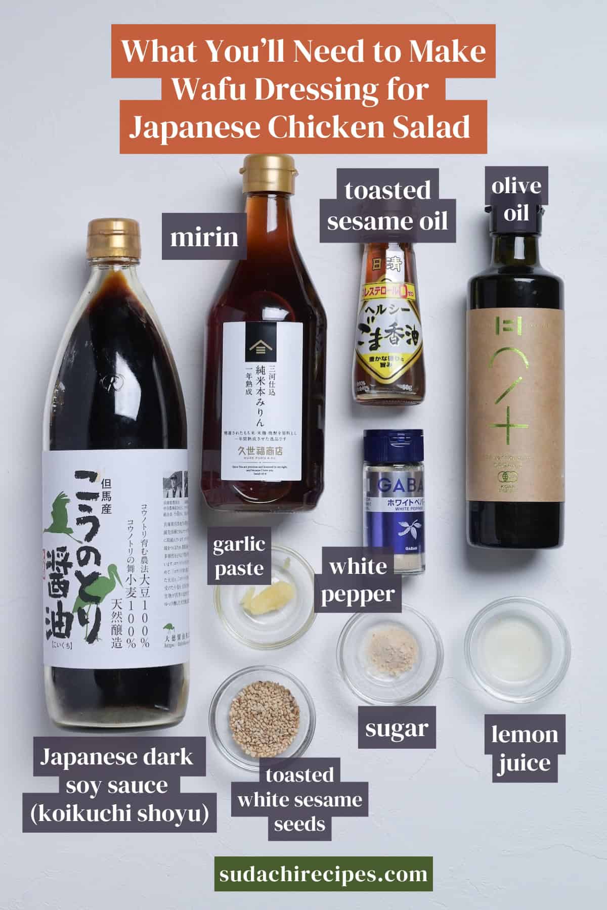 Ingredients for wafu dressing for Japanese chicken salad on a white background with labels. From top to bottom, left to right: mirin, taosted sesame oil, olive oil, garlic paste, white pepper, Japanese dark soy sauce, toasted white sesame seeds, sugar, lemon juice