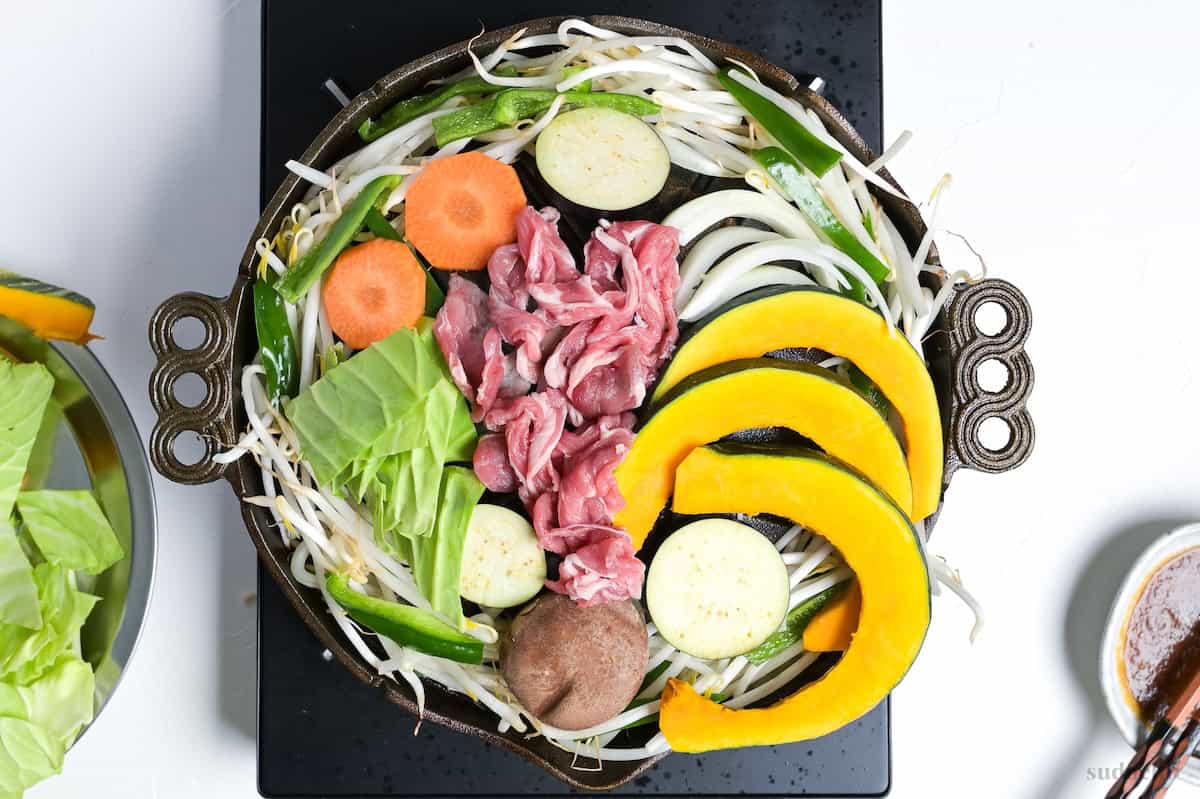 Hokkaido style Jingisukan with thinly sliced lamb and vegetables on a Mongolian style BBQ grill