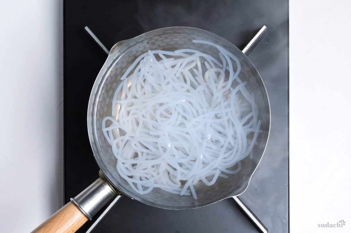 shirataki noodles boiling in a small pot of water on the stove top