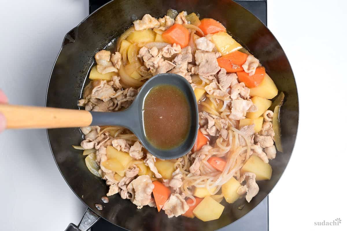 nikujaga broth in a ladle
