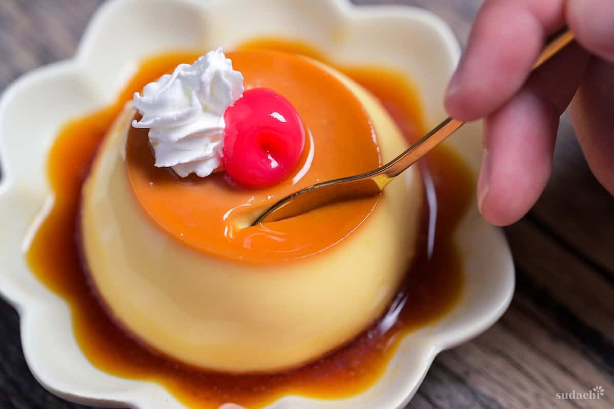 A spoon scooping Japanese oven-baked purin