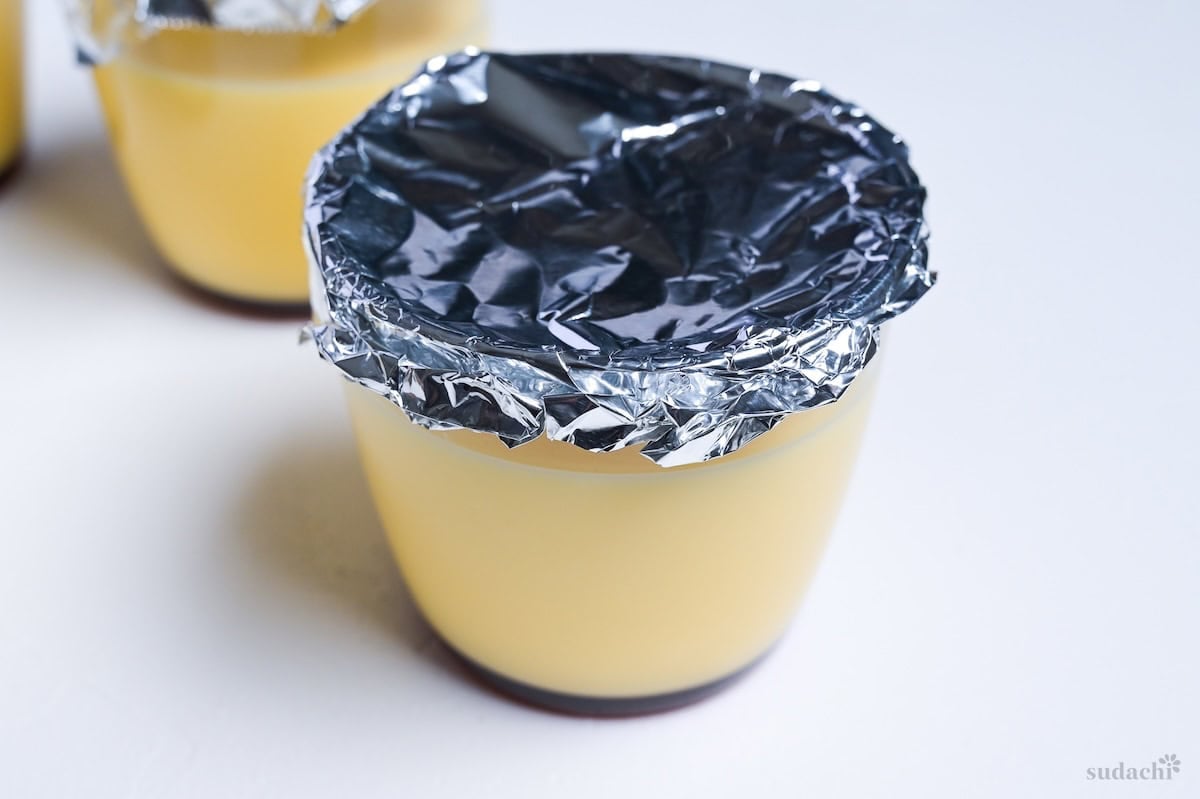 side view of purin cup with foil lid before baking
