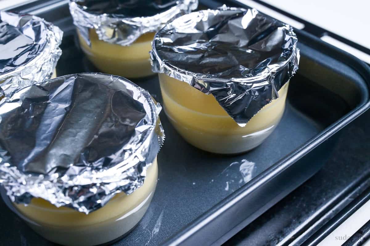 Purin cups in a hot water bath filled up two thirds of the way