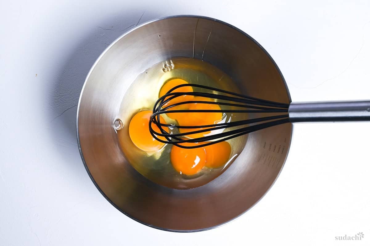 Whisking eggs in a steel mixing bowl