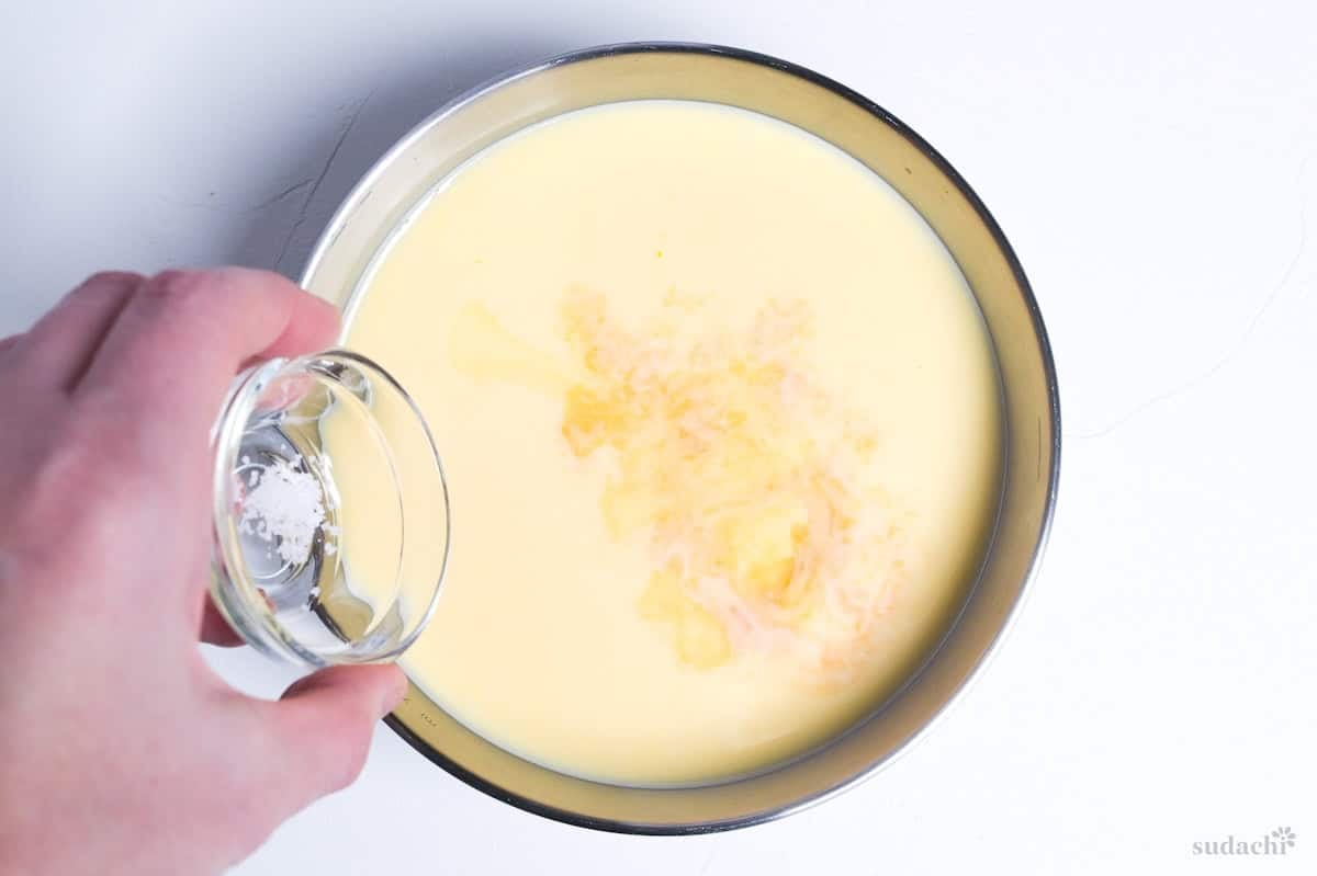 adding vanilla essence and a pinch of salt to purin mixture