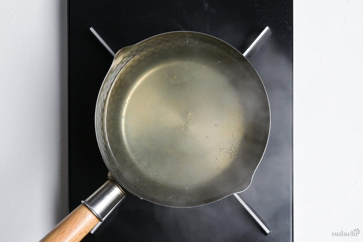 dashi stock simmering in a pot on the stove top