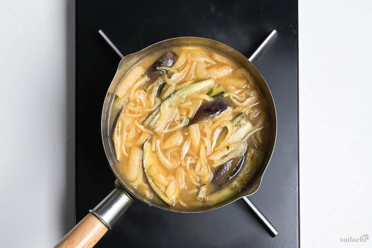 eggplant miso soup simmering in a pot on the stove top