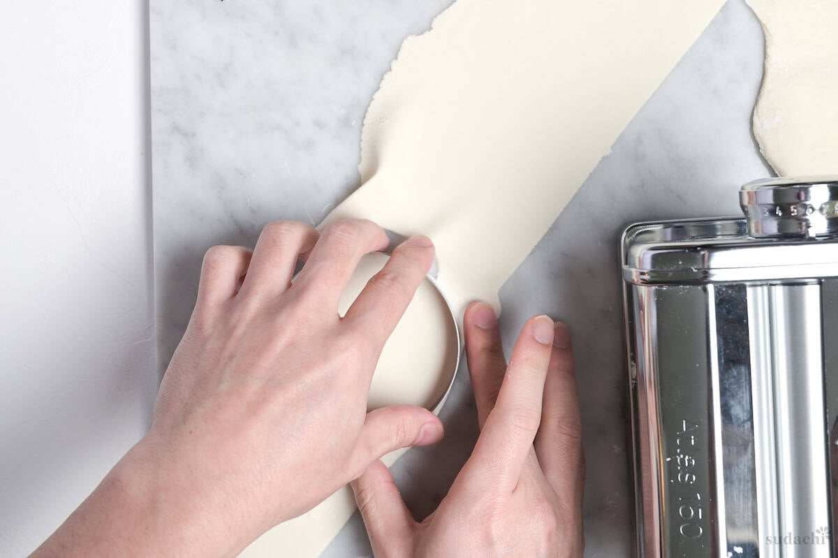 cutting rolled gyoza skin dough with a round cutter