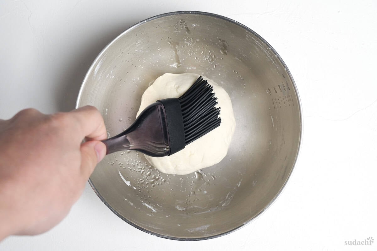 brushing kneaded gyoza skin dough with oil