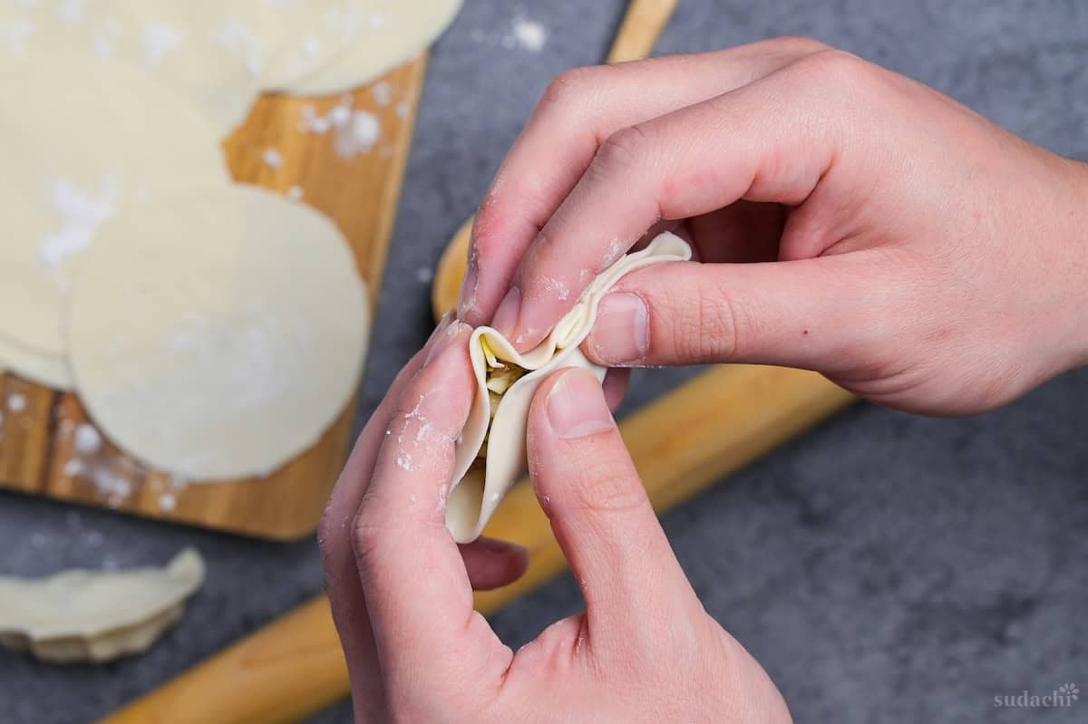 Using homemade gyoza skin to fold gyoza with filling