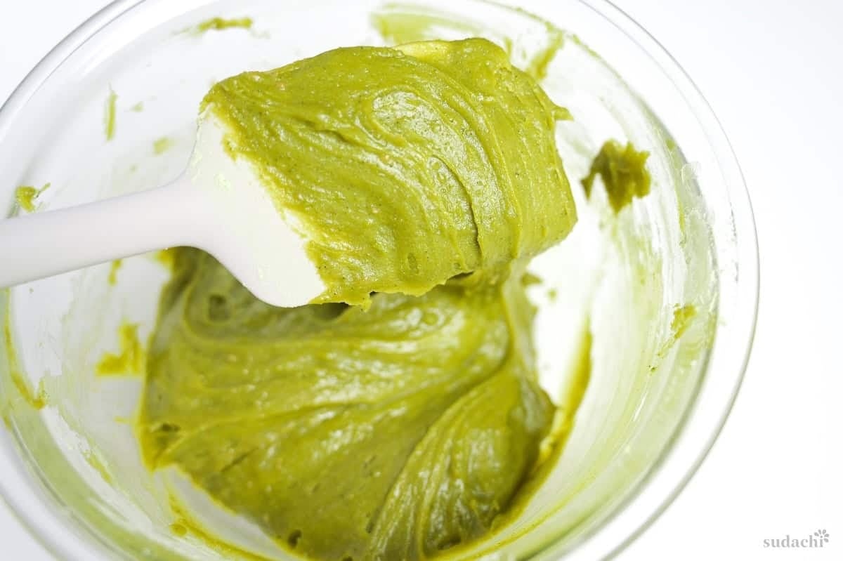 matcha blondie mixture on a silicone spatula to show thickness
