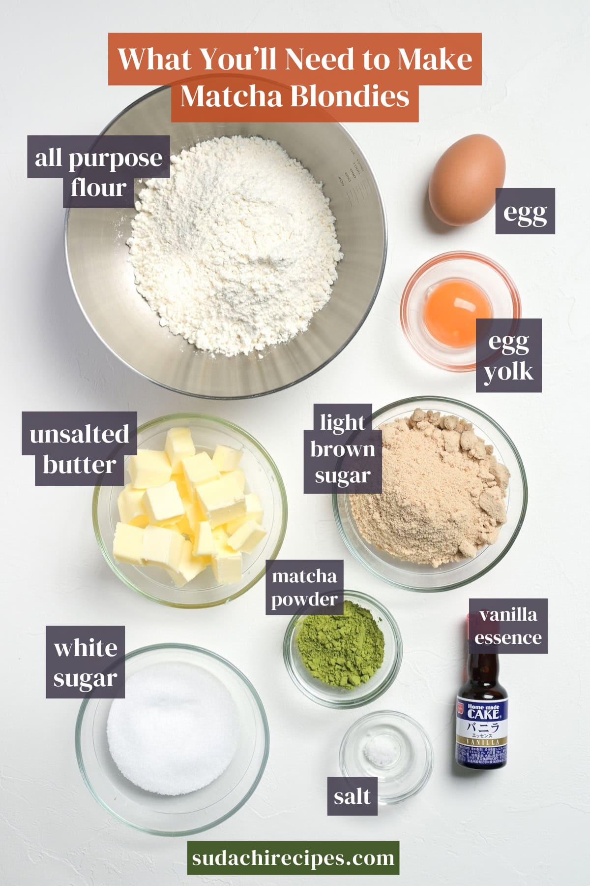 Ingredients needed to make matcha blondies on a white background. From top to bottom, left to right: all purpose flour, egg, egg yolk, unsalted butter, light brown sugar, white sugar, matcha powder, vanilla essence, salt.