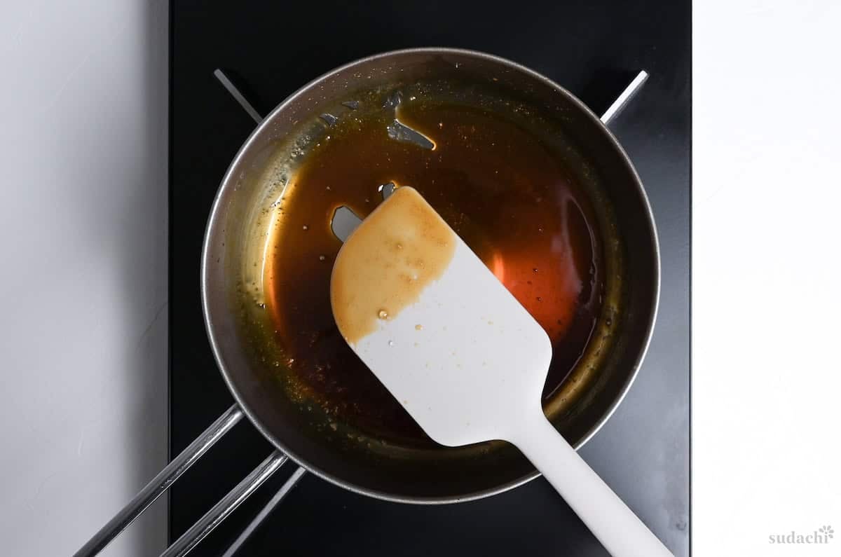 thickened mitarashi sauce in a saucepan on the stove top