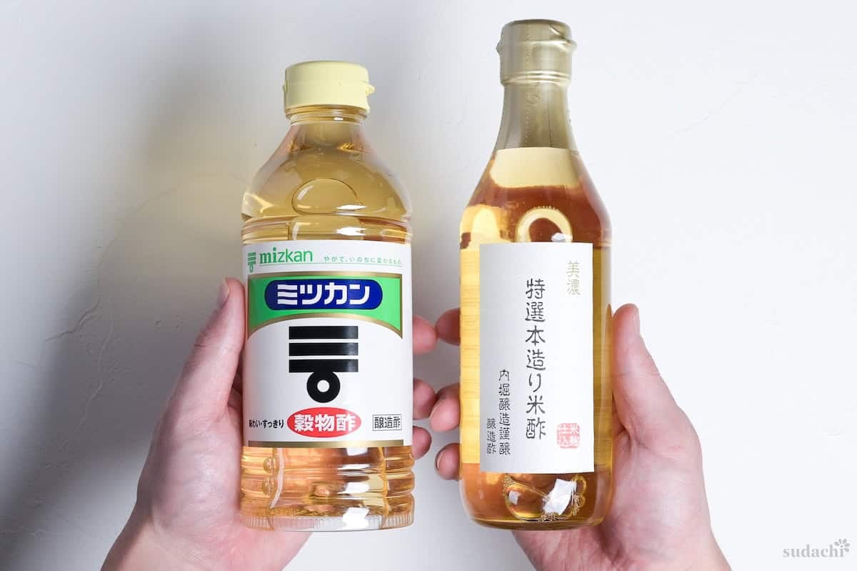 Yuto Omura holding up two bottles of Japanese rice vinegar