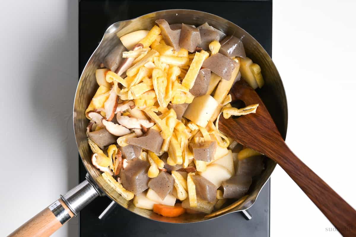 Searing tonjiru ingredients in a pot on the stove top.