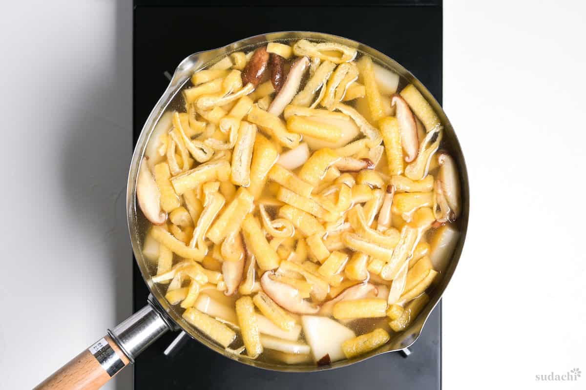 Tonjiru simmering in a pot on the stove top.