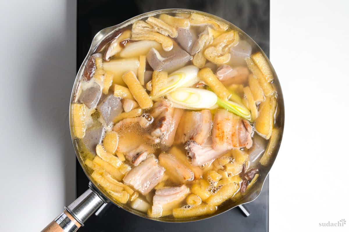 Tonjiru simmering in a pot on the stove top.